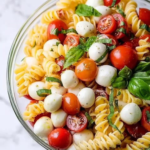 Eine Schüssel Nudeln mit Tomaten und Käse.