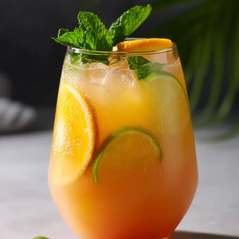 Ein Glas O-Saft mit Zitronenscheibe.