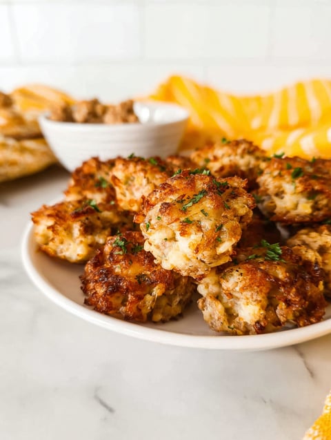 Ein Teller mit knusprigen Hashbrown Wurst Häppchen